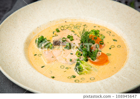 fish soup with green onions, carrots and broccoli side view 108945647