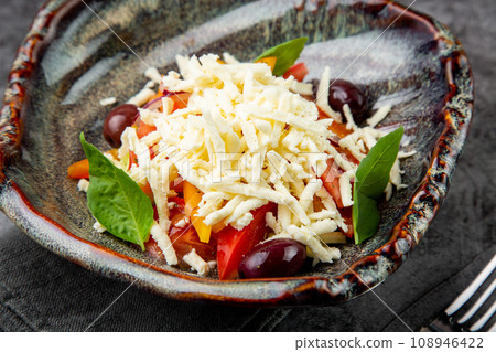 cherry tomatoes, spinach, eel, lime, cheese, side view 108946422