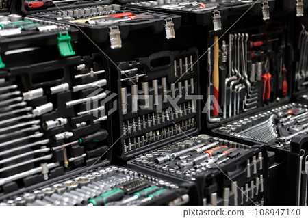 plastic boxes with mechanic tool sets on showcase 108947140