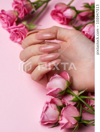 Female hands with beautiful manicure on pink background Female hands with beautiful manicure on pink background 108947813