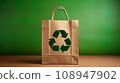 Paper bag with recycling symbol on green background. recyclable packaging concept 108947902