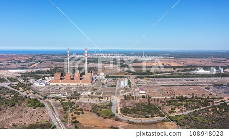 Aerial view of a coal-fired power plant in the city of Sines, in background the sea in Portugal and industrial port. Aerial view of a coal-fired power plant in the city of Sines, in background the sea in Portugal and industrial port. 108948028