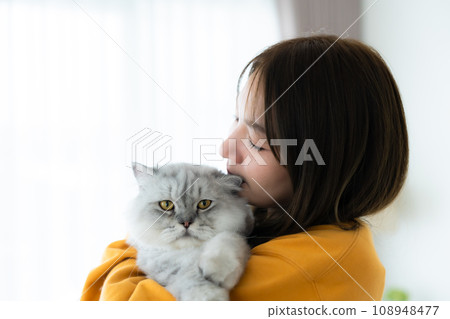 Portrait of young Asian woman holding cute cat 108948477