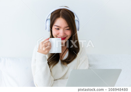 Morning Time in Bedroom Young Asian Woman Happy Drinking Milk 108948480