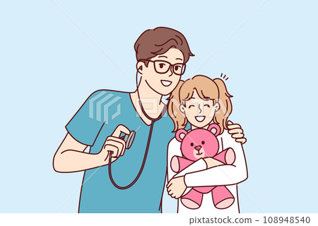 Man pediatrician hugs little girl with toy before examination and holds stethoscope 108948540