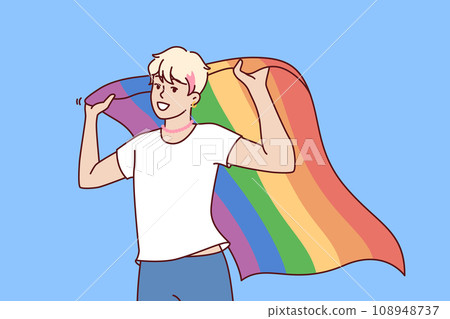 LGBT guy holds rainbow flag, openly announcing sexual orientation and participating in pride month LGBT guy holds rainbow flag, openly announcing sexual orientation and participating in pride month 108948737