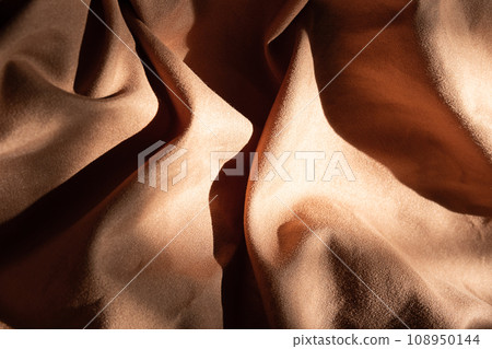 Brown textured wavy fabric in hard light. Brown textured wavy fabric in hard light. 108950144