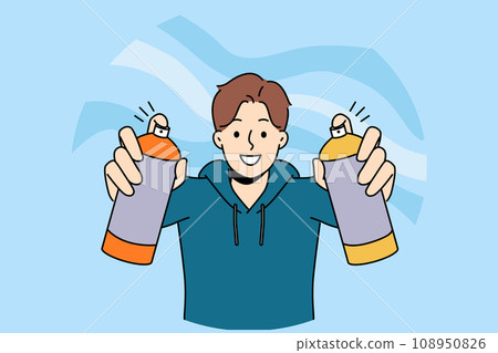 Man street artist draws graffiti holding two cans of paint in hands and with smile looks at screen 108950826