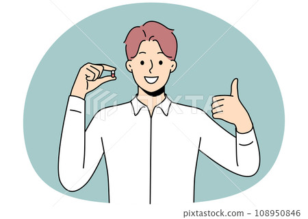 Smiling man hold pill show thumb up Smiling man hold pill show thumb up 108950846
