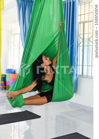 Young woman making aerial or fly yoga pose Young woman making aerial or fly yoga pose 108950956