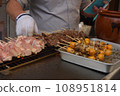 Grilling yakitori at a food stall 108951814