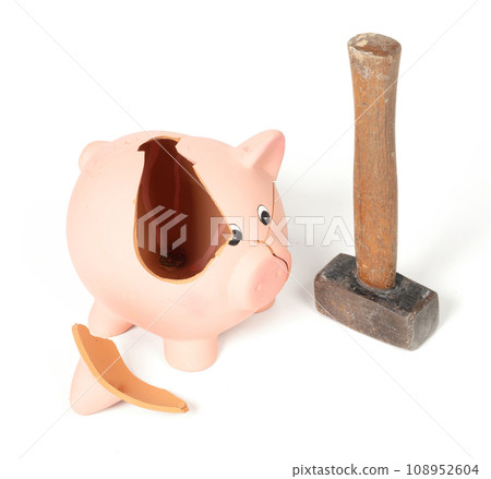 Hammer breaking piggy bank isolated Hammer breaking piggy bank isolated 108952604