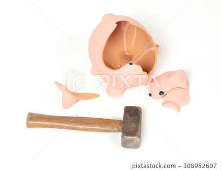 Hammer breaking piggy bank isolated Hammer breaking piggy bank isolated 108952607