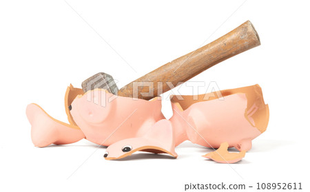 Hammer breaking piggy bank isolated Hammer breaking piggy bank isolated 108952611