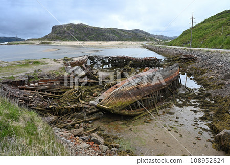 Cemetery of old ships on the coast of the Barents Sea in Teriberka, Russia 108952824