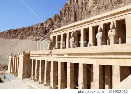 Deir el-Bahari (Deir el-Bahri) the Mortuary Temple of Hatshepsut in Valley of the Kings, Luxor, Egypt. Statues of Queen Hatshepsut, facade of the Hatshepsut temple in Western Thebes Deir el-Bahari (Deir el-Bahri) the Mortuary Temple of Hatshepsut in Valley of the Kings, Luxor, Egypt. Statues of Queen Hatshepsut, facade of the Hatshepsut temple in Western Thebes 108952982