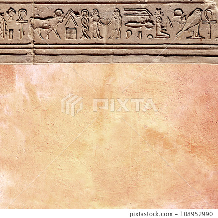 Vertical background with ancient Egyptian hieroglyphs on stone wall, Egypt, Africa. Backdrop with sandstone carving with hieroglyph. Mock up template. Copy space for text 108952990