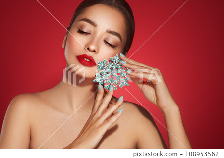 Beautiful young woman with glowing snowflake Beautiful young woman with glowing snowflake 108953562