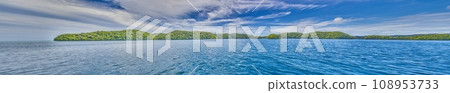 Panoramic view over turquoise blue water to a tropical island in Palau 108953733