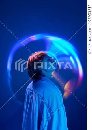 Sie view of young attractive man enjoying atmosphere in neon colorful light and illuminated vivid abstract, creative digital reflection. 108953813