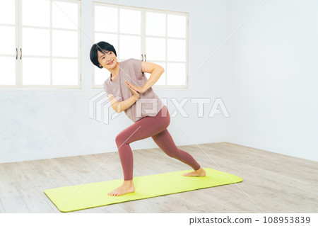 Middle-aged woman doing yoga at a yoga studio 108953839