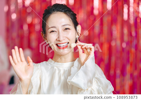 Woman wearing head microphone and waving, idol, actress, stage 108953873