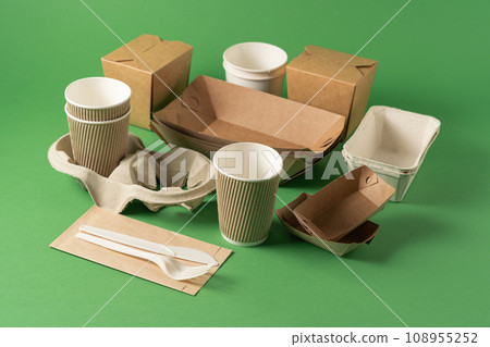 Packaging concept - selection of paper craft packaging on green Packaging concept - selection of paper craft packaging on green 108955252
