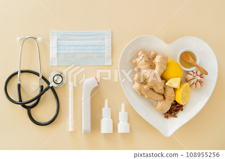 Natural immune system boosters - lemon, ginger, garlic, honey and drugs, thermometer, stethoscope 108955256