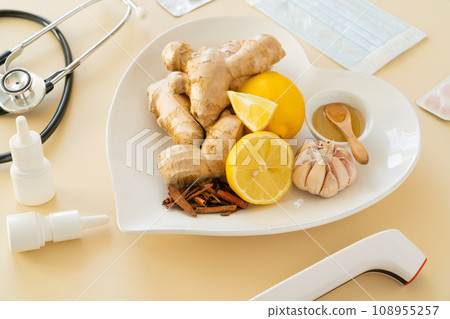 Natural cold remedies concept - ginger tea and ingredients, drugs, thermometer 108955257