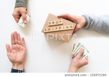 Drop shipping concept - hands exchanging money and product 108955260
