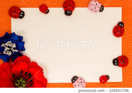Frame of bright artificial flowers and ladybirds - a multi-colored, background Frame of bright artificial flowers and ladybirds - a multi-colored, background 108955706