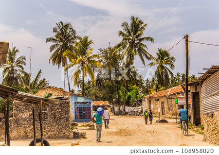 African road through village people going about business 108958020