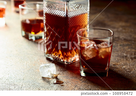 Whiskey in frosted glass with ice. 108958472