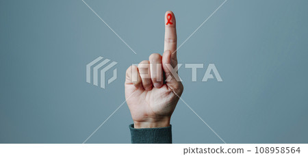 finger with red ribbon for the fight against AIDS 108958564