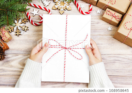 The girl holds children's Christmas letters. Christmas letters with gift box and christmas decoration 108958645