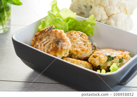 cooked vegetarian fried cauliflower cutlets, in a ceramic form . cooked vegetarian fried cauliflower cutlets, in a ceramic form . 108958852