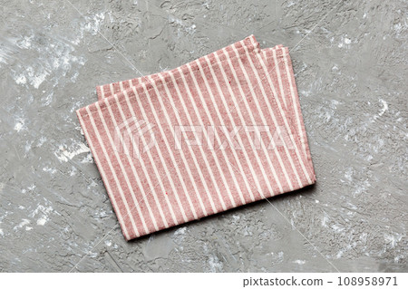 top view with red empty kitchen napkin isolated on table background. Folded cloth for mockup with copy space, Flat lay. Minimal style top view with red empty kitchen napkin isolated on table background. Folded cloth for mockup with copy space, Flat lay. Minimal style 108958971