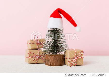 Christmas composition. Gifts, small tree, branches and craft DIY decorations on white background. New year concept. Christmas home decoration Flat lay, top view, copy space 108959042