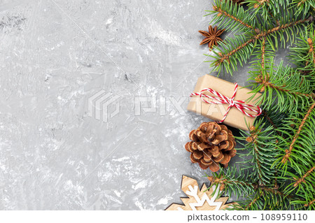 Christmas background with fir tree and gift box on wooden table. Top view with copy space for your design Christmas background with fir tree and gift box on wooden table. Top view with copy space for your design 108959110