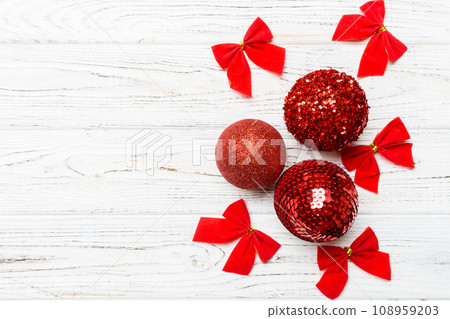Creative set of New Year baubles and decorations on wooden background. Top view of Christmas time concept. Copy space 108959203