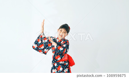 A girl wearing a yukata and dancing Bon Odori 108959875