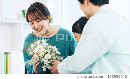 Girl and family giving gifts Girl and family giving gifts 108959940