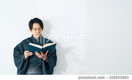 A man reading a book in Japanese clothes A man reading a book in Japanese clothes 108959965