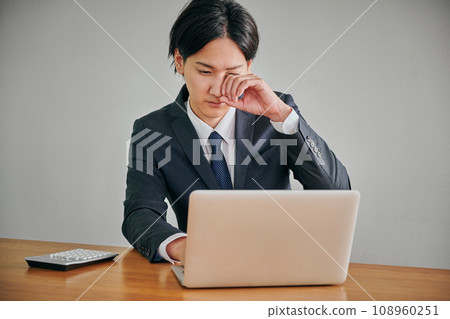 一名年輕男性上班族眼睛發癢,用手指揉眼睛 一名年輕男性上班族眼睛發癢,用手指揉眼睛 108960251