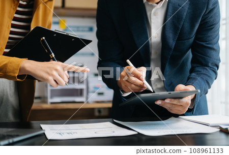 Businessman and team analyzing financial statement Finance task. with smart phone and laptop and tablet. Wealth management concept in office. Businessman and team analyzing financial statement Finance task. with smart phone and laptop and tablet. Wealth management concept in office. 108961133