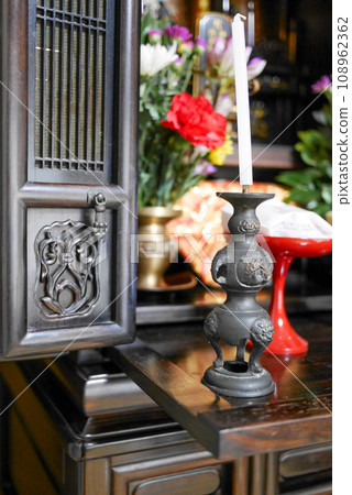 Buddhist altar with flowers and offerings 108962362