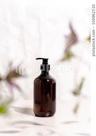 Brown bottle mockup for bathing products in bathroom, spa shampoo, shower gel, liquid soap in frame from flowers Brown bottle mockup for bathing products in bathroom, spa shampoo, shower gel, liquid soap in frame from flowers 108962510