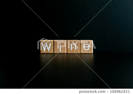 Wooden blocks form the text "Wine" against a black background. 108962831