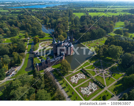 Top view of the largest castle in the Netherlands, De Haar. A beautiful quadcopter flight over the castle, the park and the water moat around the castle. A beautiful park in English style. Top view of the largest castle in the Netherlands, De Haar. A beautiful quadcopter flight over the castle, the park and the water moat around the castle. A beautiful park in English style. 108963807