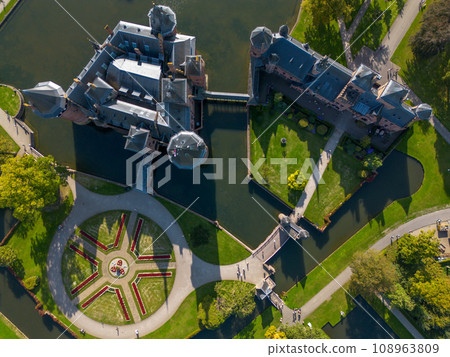 Top view of the largest castle in the Netherlands, De Haar. A beautiful quadcopter flight over the castle, the park and the water moat around the castle. A beautiful park in English style. Top view of the largest castle in the Netherlands, De Haar. A beautiful quadcopter flight over the castle, the park and the water moat around the castle. A beautiful park in English style. 108963809